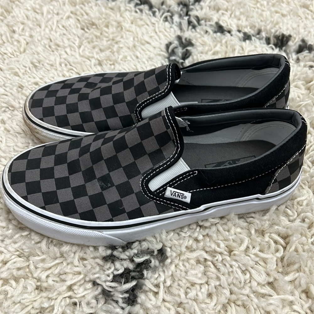 Gently used black and grey checkered Van classic slip-ons